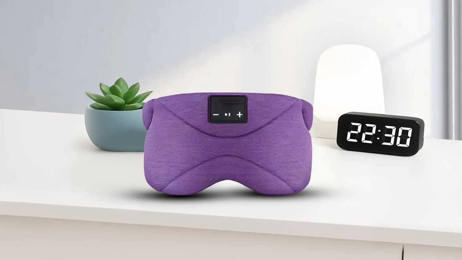 bandeau de sommeil Bluetooth de couleur gris. Bloque la lumière et réduit le bruit. Diffuse des sons relaxants